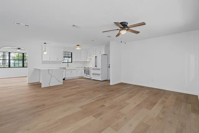 a view of a kitchen with a sink and cabinets
