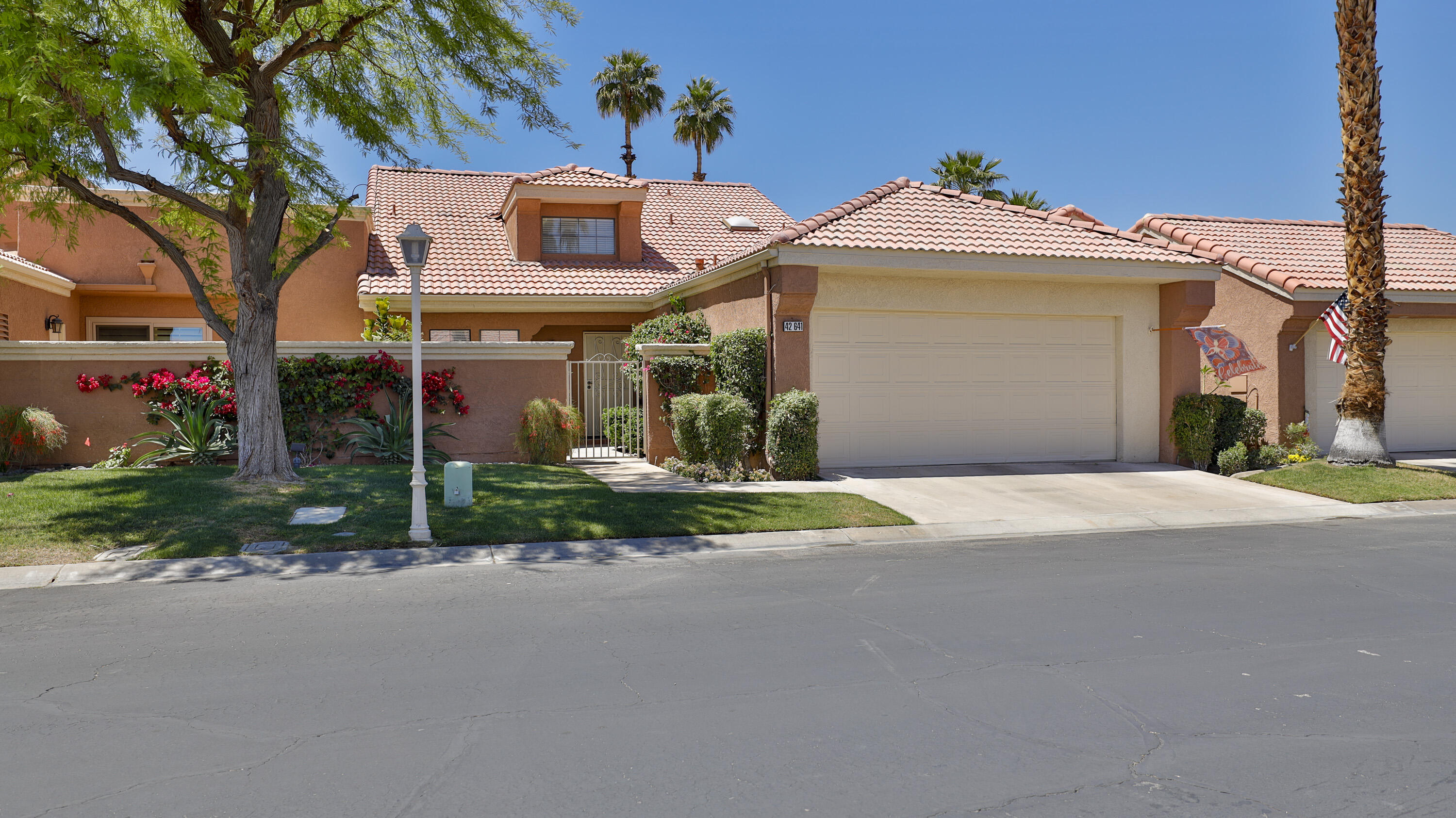 42641 Liolios Drive Palm Desert, CA 92211 - Photo 2 of 44 a front view of a house with garden