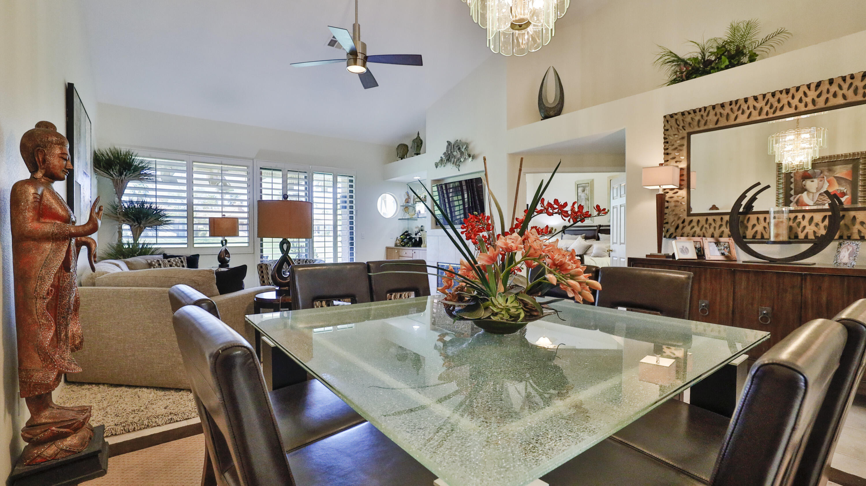 42641 Liolios Drive Palm Desert, CA 92211 - Photo 12 of 44 a view of a dining room with furniture a chandelier and wooden floor