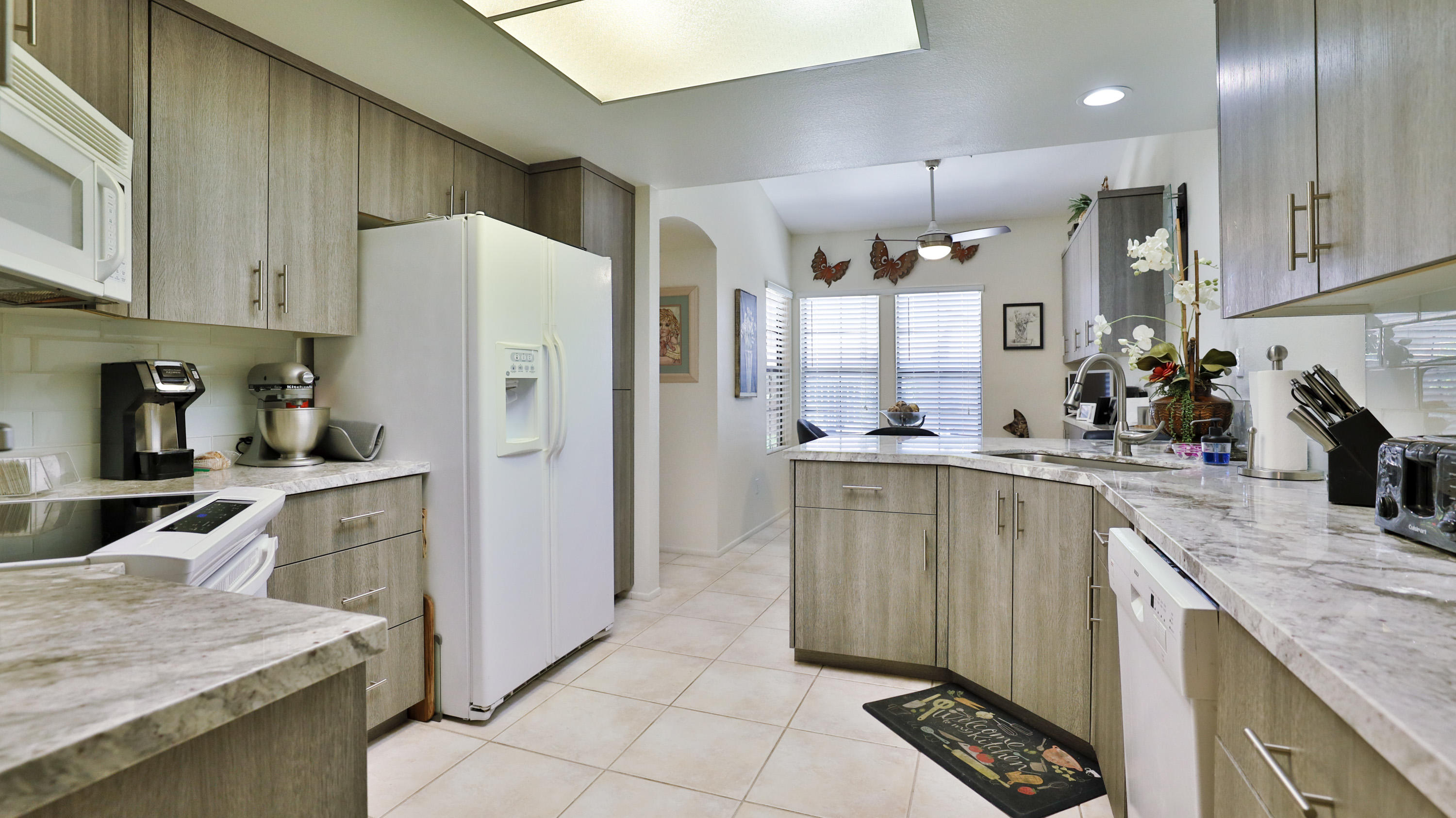 42641 Liolios Drive Palm Desert, CA 92211 - Photo 16 of 44 a kitchen with a refrigerator a sink and cabinets
