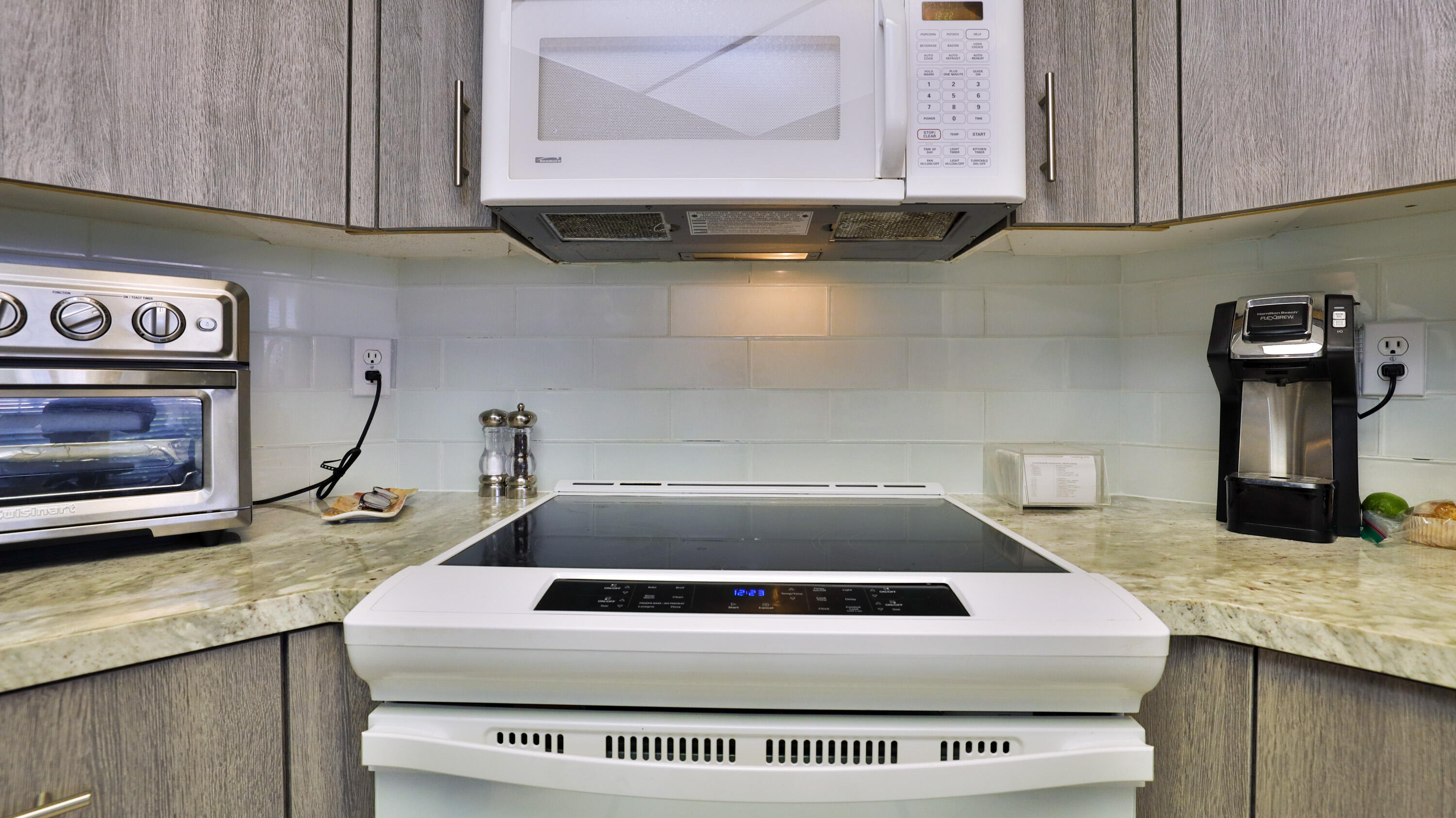 42641 Liolios Drive Palm Desert, CA 92211 - Photo 17 of 44 a kitchen with granite countertop a stove and a sink