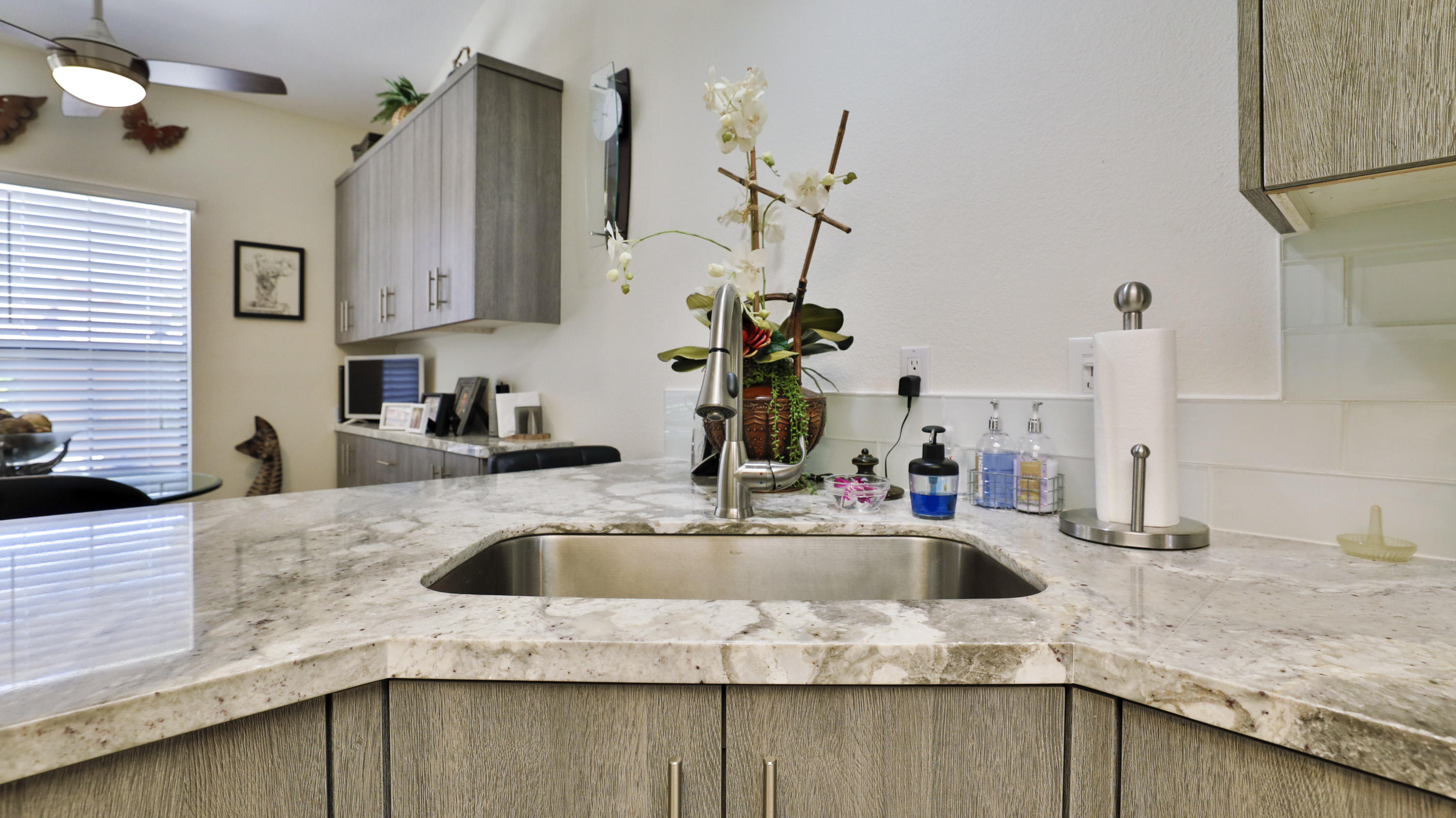 42641 Liolios Drive Palm Desert, CA 92211 - Photo 18 of 44 a kitchen with granite countertop a sink and a stove