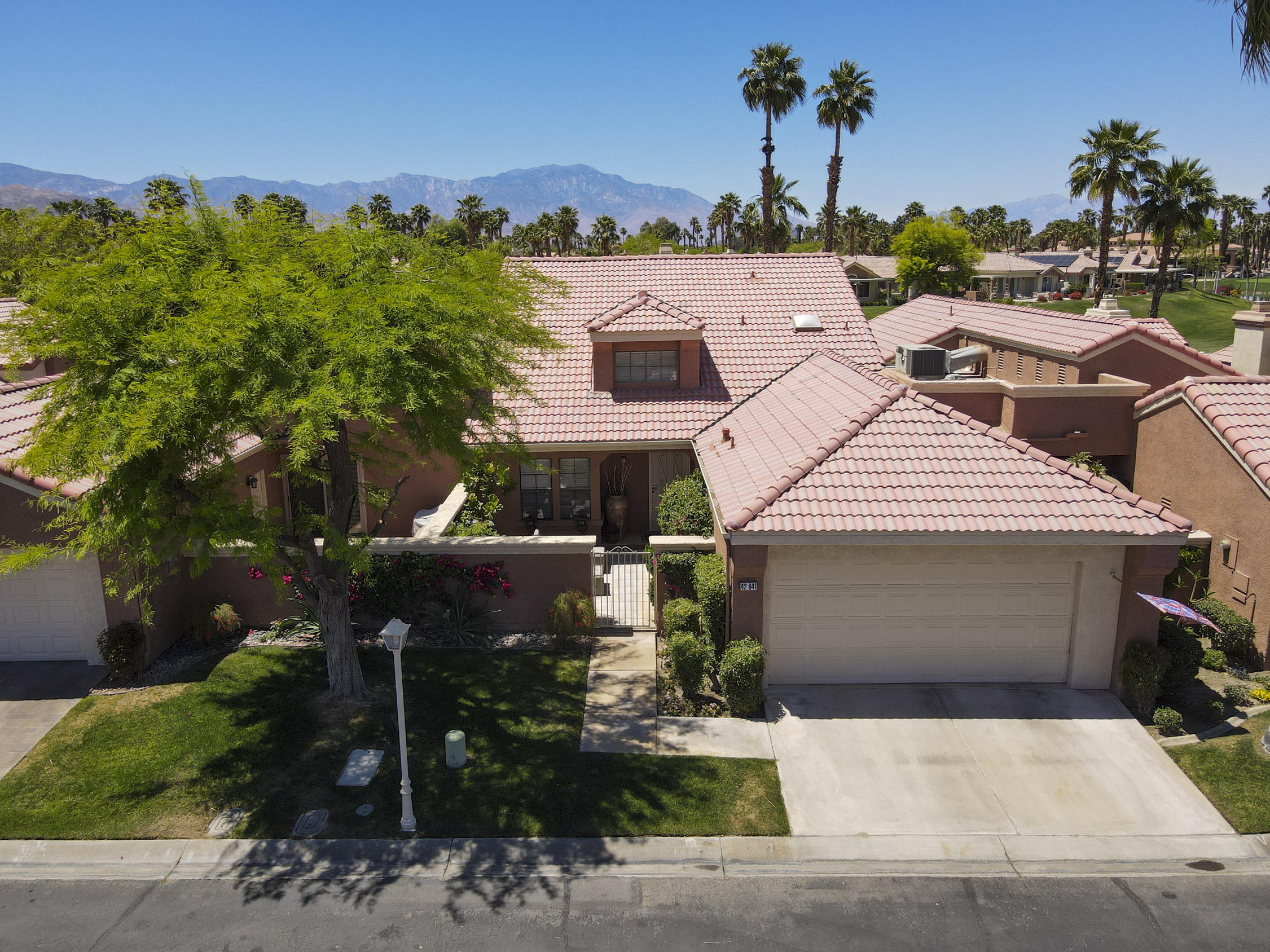 42641 Liolios Drive Palm Desert, CA 92211 - Photo 3 of 44 front view of a house with a street