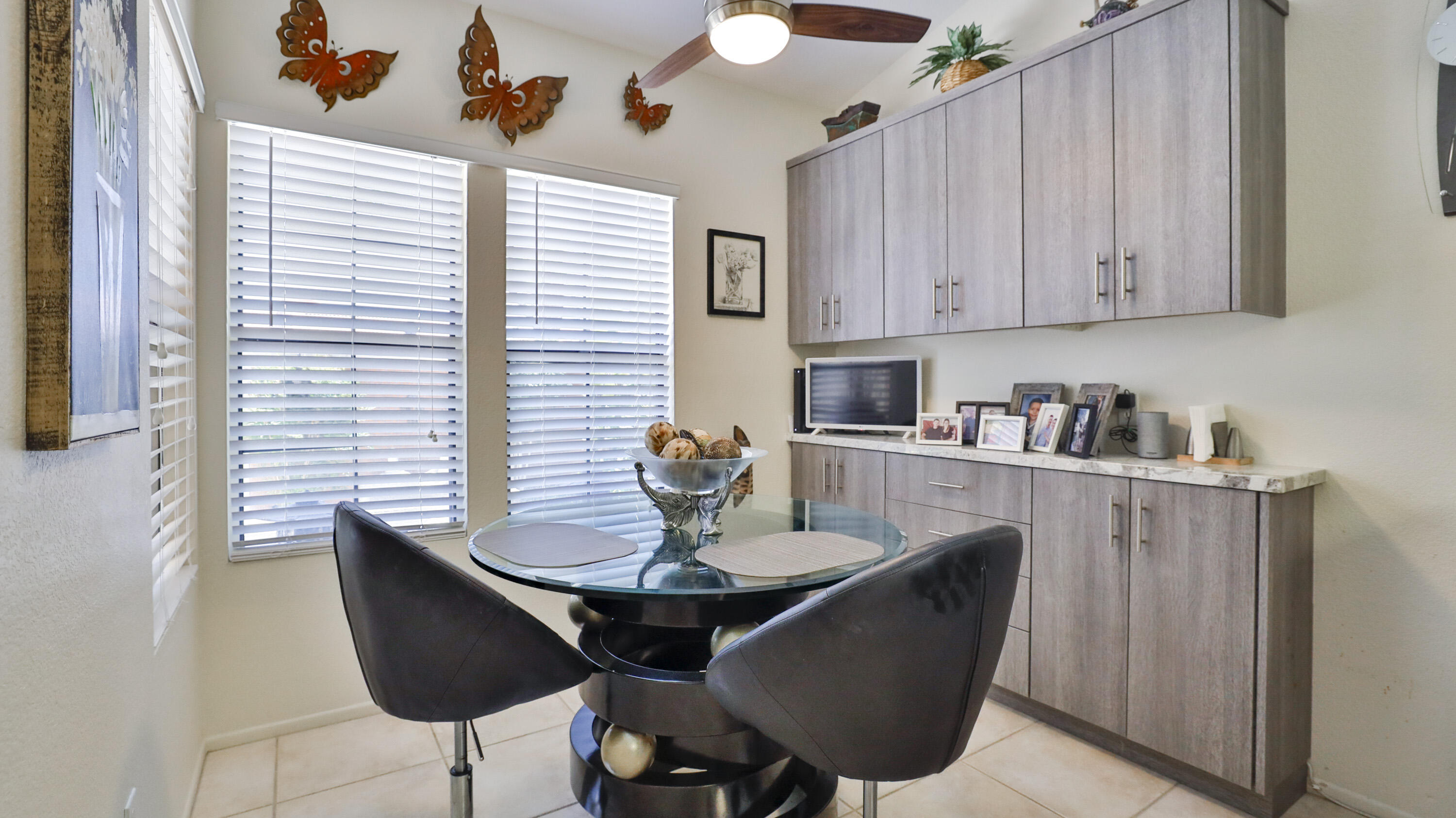 42641 Liolios Drive Palm Desert, CA 92211 - Photo 21 of 44 a kitchen with a table chairs and a refrigerator