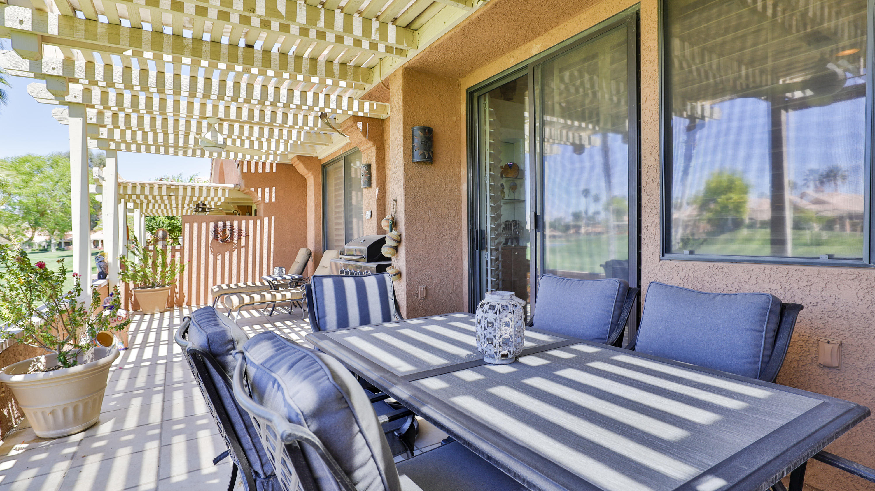 42641 Liolios Drive Palm Desert, CA 92211 - Photo 35 of 44 a view of a dining room with furniture window and wooden floor