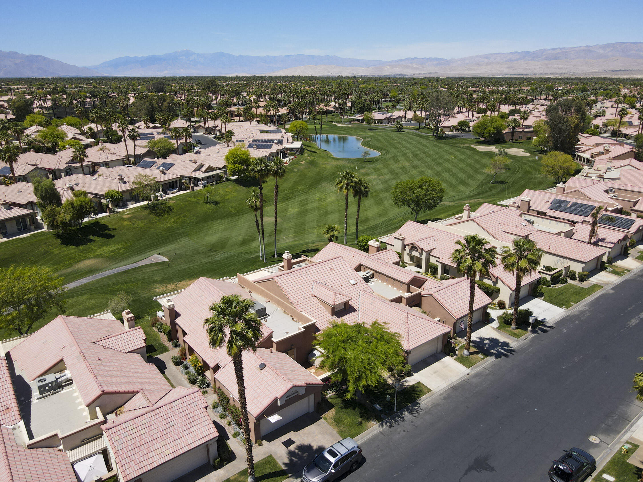 42641 Liolios Drive Palm Desert, CA 92211 - Photo 43 of 44 an aerial view of a house with a garden and lake view