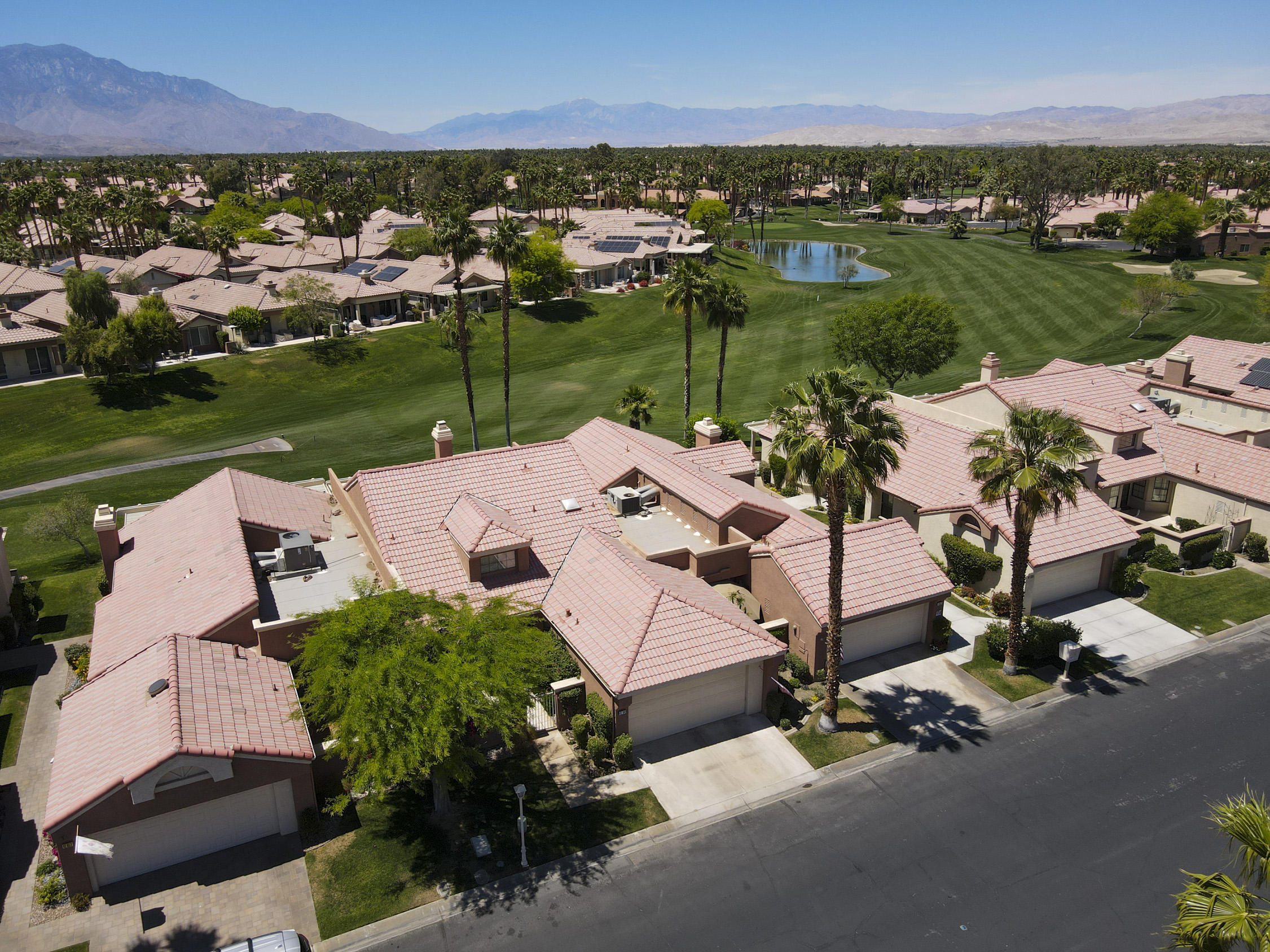 42641 Liolios Drive Palm Desert, CA 92211 - Photo 44 of 44 an aerial view of a house with a garden and lake view