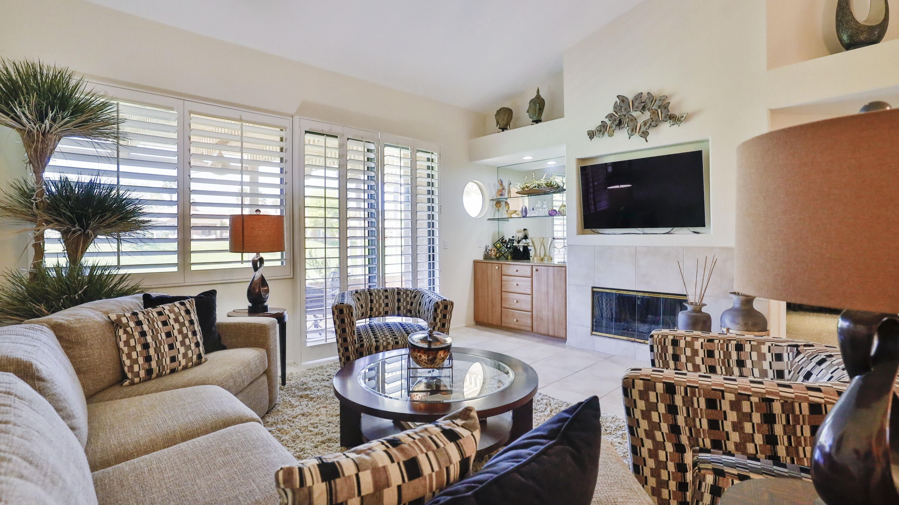 42641 Liolios Drive Palm Desert, CA 92211 - Photo 8 of 44 a living room with furniture a fireplace and a flat screen tv