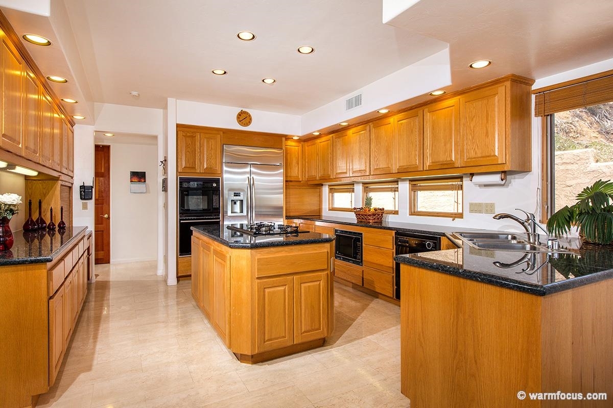 4610 Rancho Reposo Del Mar, CA 92014 - Photo 11 of 25 Beautiful granite and stainless steel appliances are anchored by the built-in refrigerator just installed this year.