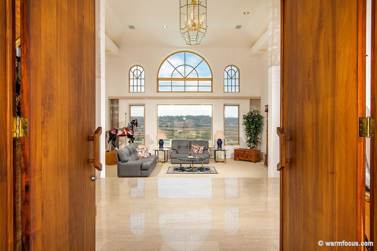 4610 Rancho Reposo Del Mar, CA 92014 - Photo 4 of 25 Light marble draws you in for your first glimpse of this magnificent view through these lovely living room windows.