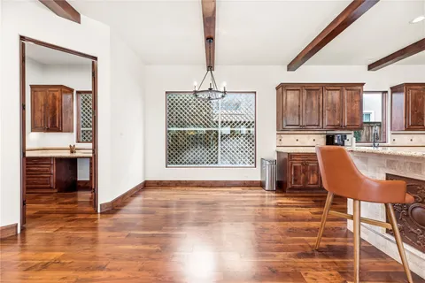 a living room with furniture pool table and a potted plant