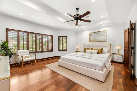 a bedroom with a large bed and a tv