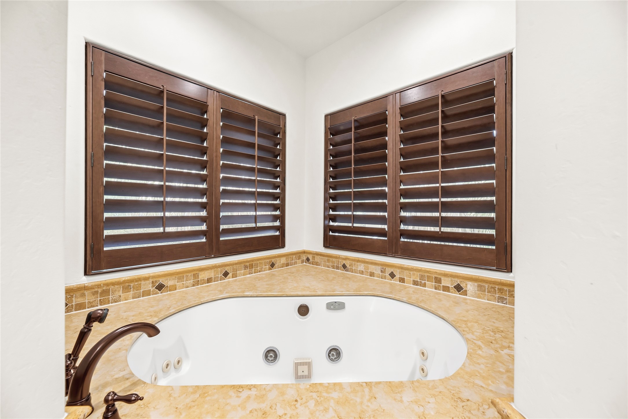 3803 Drake Street Houston, TX 77005 - Photo 18 of 32 a bathroom with a bathtub and next to a window