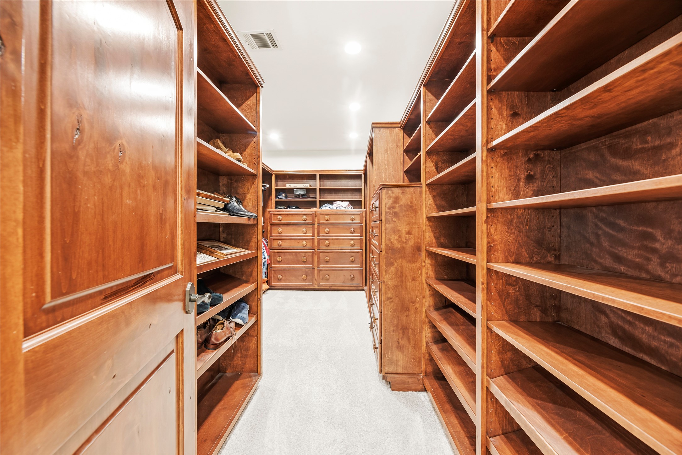 3803 Drake Street Houston, TX 77005 - Photo 19 of 32 a view of walk in closet with clothes and shoes