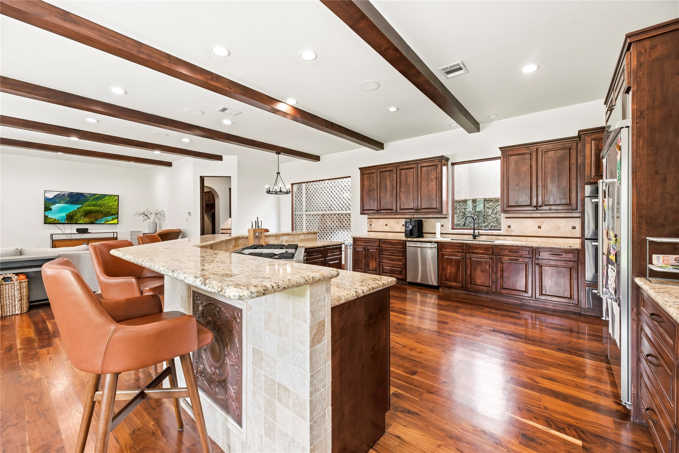 3803 Drake Street Houston, TX 77005 - Photo 2 of 32 This chef-inspired kitchen features premium granite, a high-end gas range with griddle, and double ovens, perfectly blending professional-grade utility with sophisticated style.