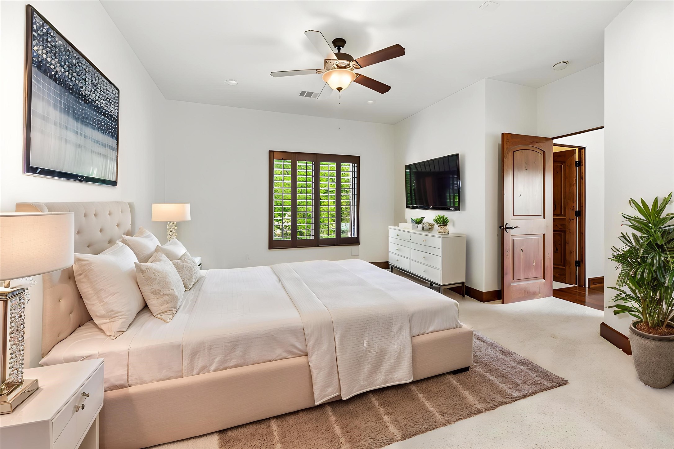 3803 Drake Street Houston, TX 77005 - Photo 23 of 32 a bedroom with a large bed and a tv