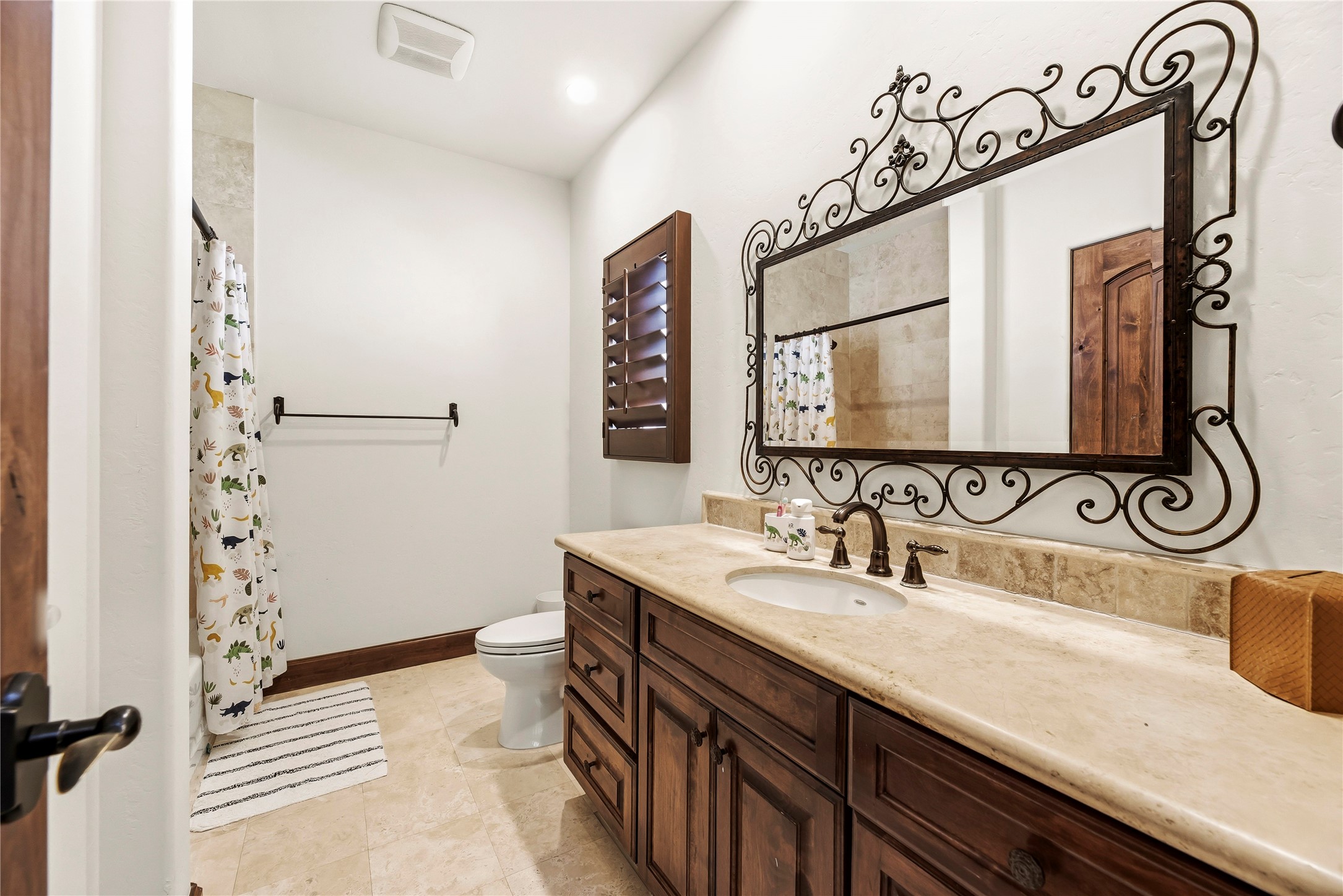 3803 Drake Street Houston, TX 77005 - Photo 25 of 32 a bathroom with a sink and a mirror
