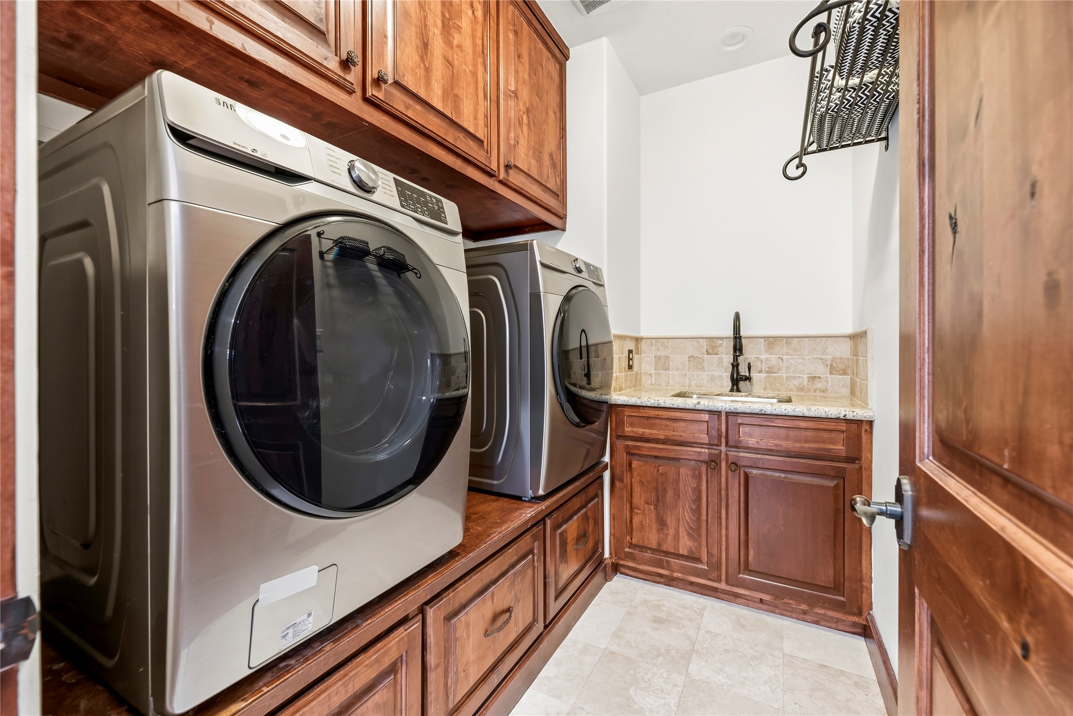 3803 Drake Street Houston, TX 77005 - Photo 26 of 32 a bathroom with a sink a washer and dryer