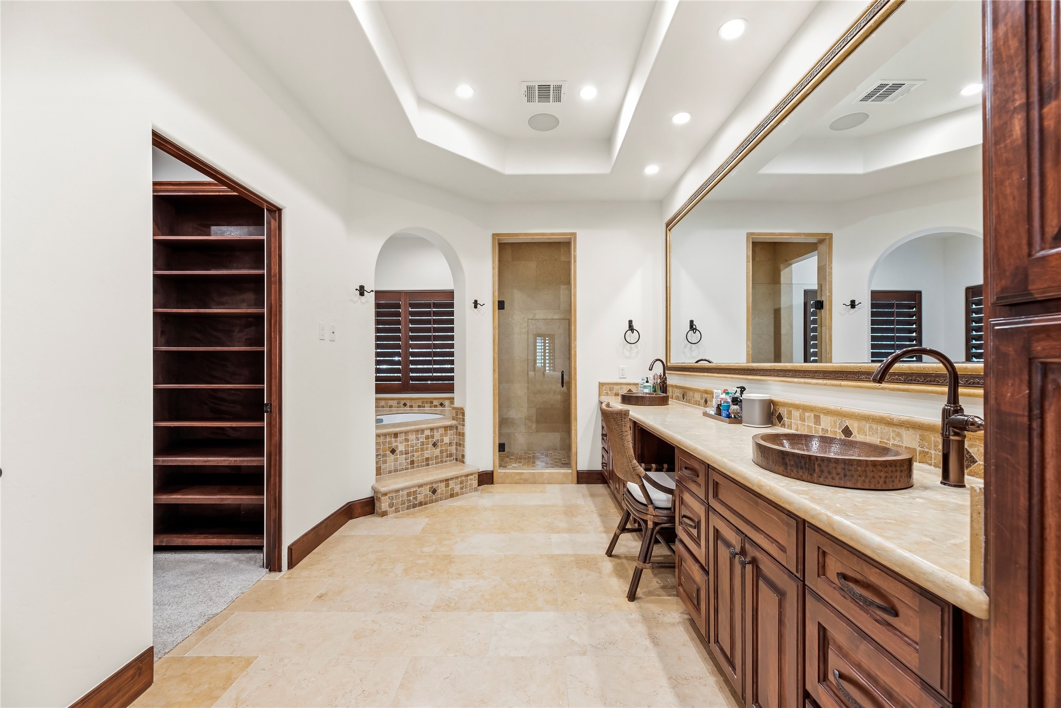 3803 Drake Street Houston, TX 77005 - Photo 3 of 32 The Primary Suite’s en-suite bath serves as a private spa with a jetted tub, separate shower, double sinks, and a generous walk-in closet for organized luxury.