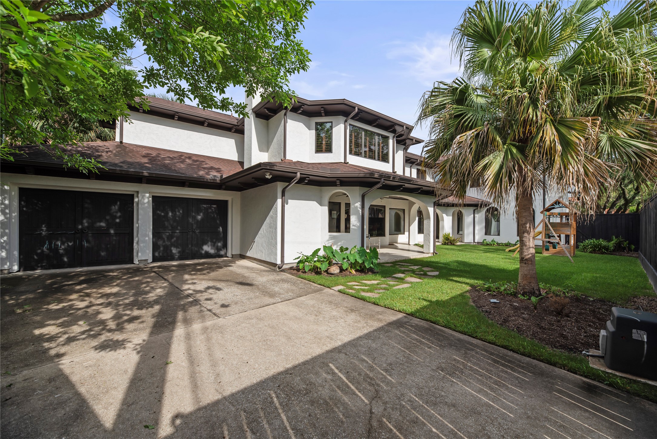 3803 Drake Street Houston, TX 77005 - Photo 31 of 32 a front view of a house with a yard and garden