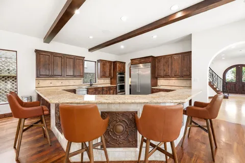 a spacious bedroom with a large bed and a chandelier