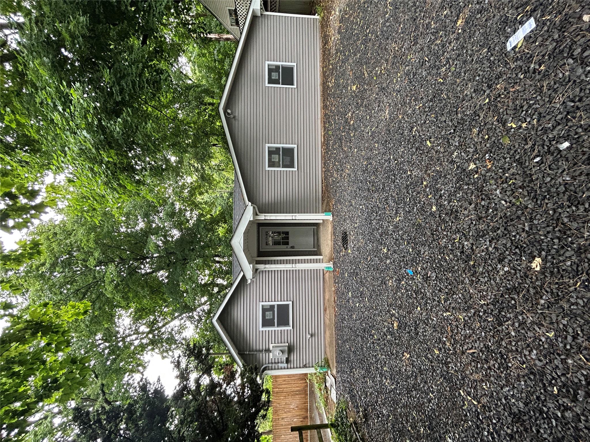 a backyard of a house with large trees