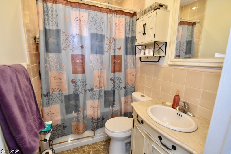 406 Morsetown Road West Milford, NJ 07480 - Photo 13 of 17 a bathroom with a sink toilet and shower