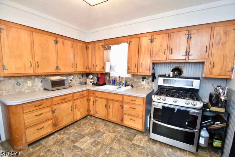 406 Morsetown Road West Milford, NJ 07480 - Photo 8 of 17 a kitchen with stainless steel appliances a stove sink and cabinets