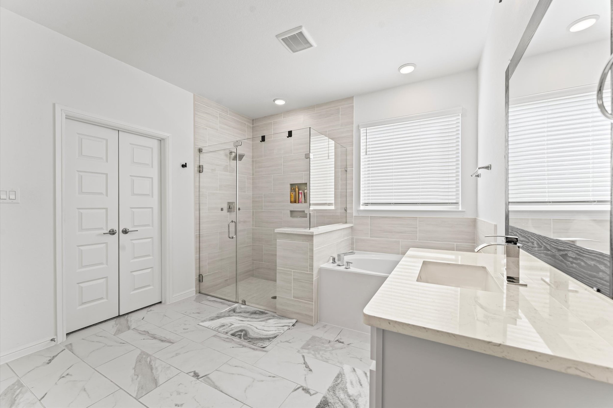 8210 Rimini Cove Court Richmond, TX 77407 - Photo 26 of 42 a bathroom with a sink mirror vanity and bathtub