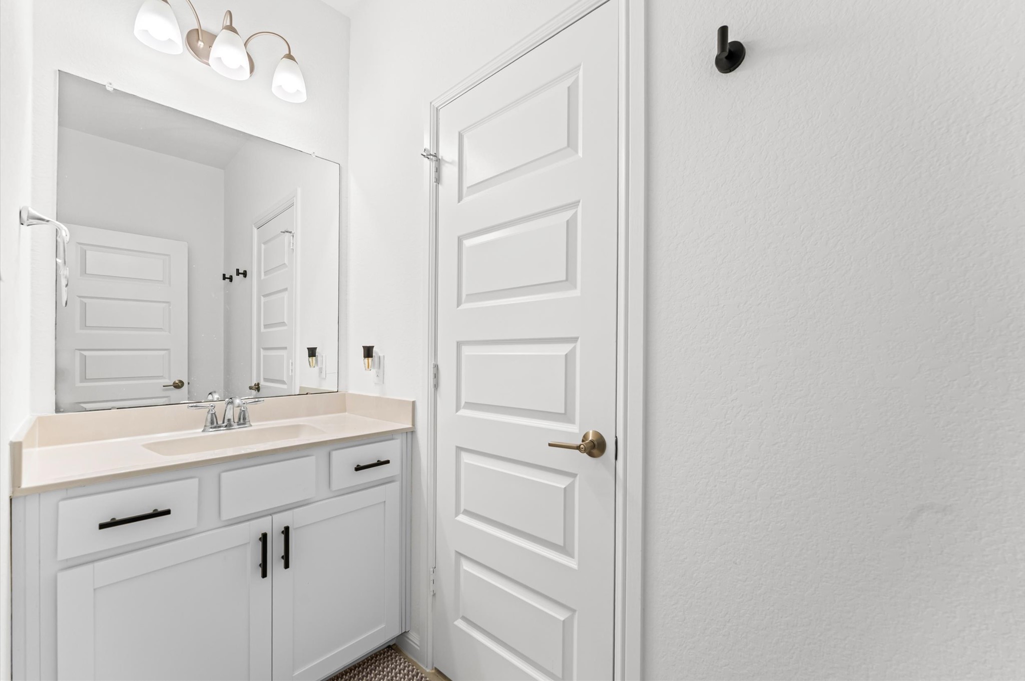 8210 Rimini Cove Court Richmond, TX 77407 - Photo 34 of 42 a bathroom with a sink vanity and mirror