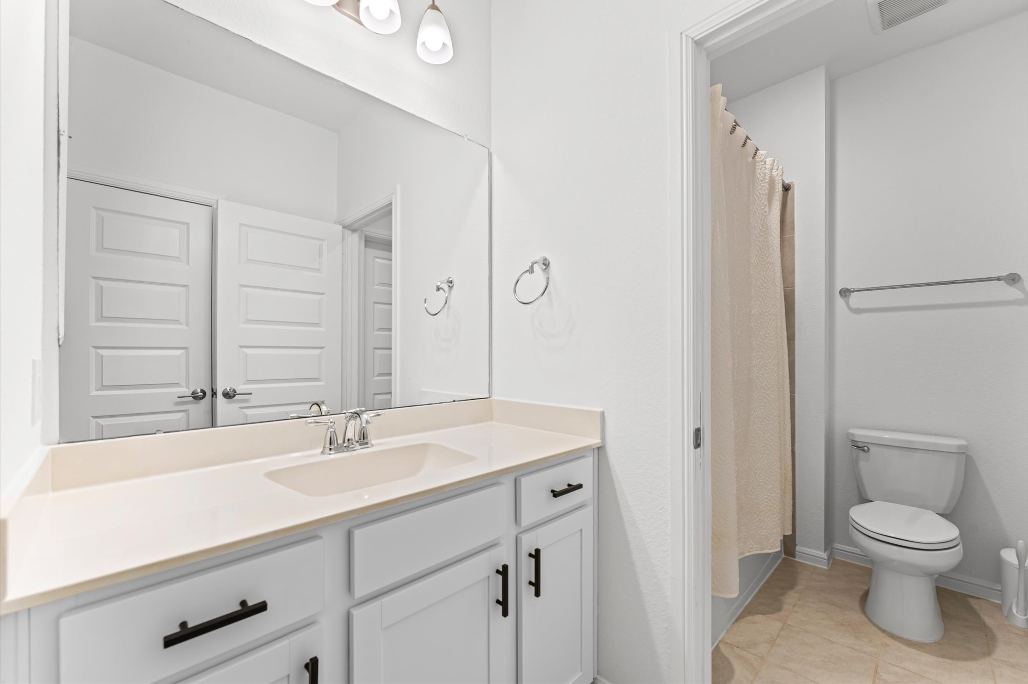 8210 Rimini Cove Court Richmond, TX 77407 - Photo 36 of 42 a bathroom with a toilet a sink a mirror and a shower
