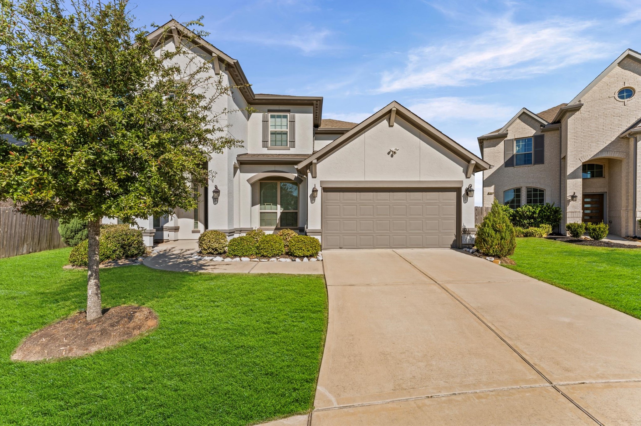 8210 Rimini Cove Court Richmond, TX 77407 - Photo 4 of 42 a front view of a house with a yard and garage