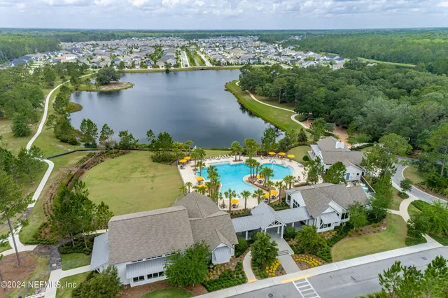an aerial view of a house with a lake view