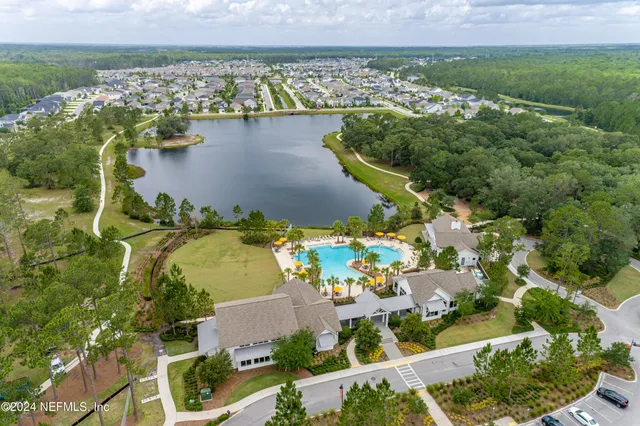 an aerial view of a house with a lake view