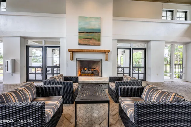 a living room with furniture fireplace and window