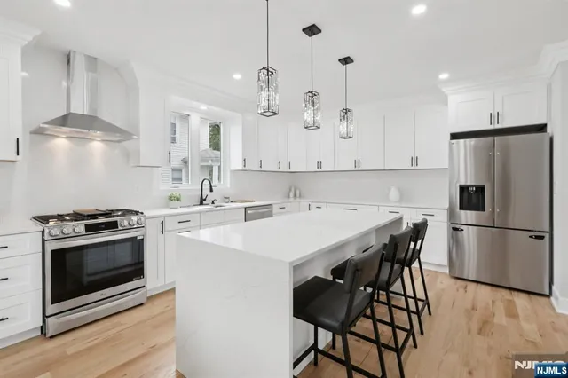 a kitchen with a stove a refrigerator and a dining table