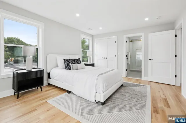 a bedroom with a bed and a large window