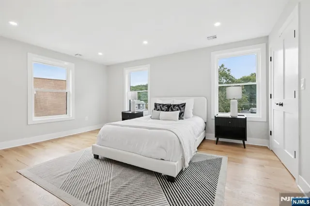 a bedroom with a large bed and a window