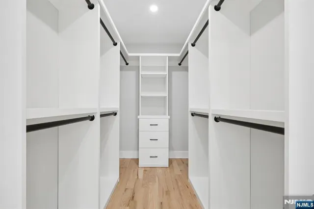 a view of walk in closet with white walls