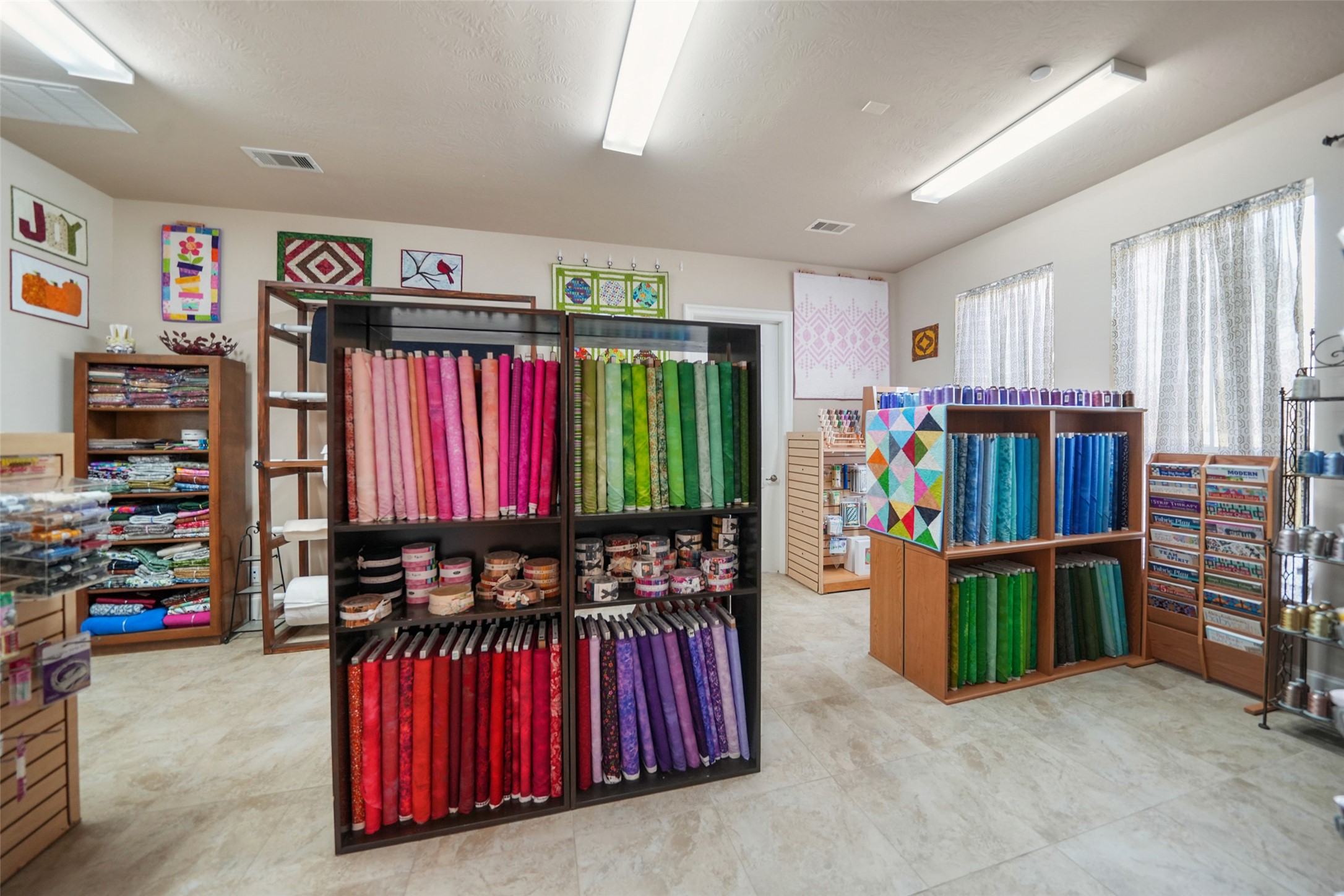 26250 A Riley Road Waller, TX 77484 - Photo 33 of 50 Spacious craft studio/flex area with ceiling fans and dedicated lighting—ideal for creative work, retail display, or group projects.