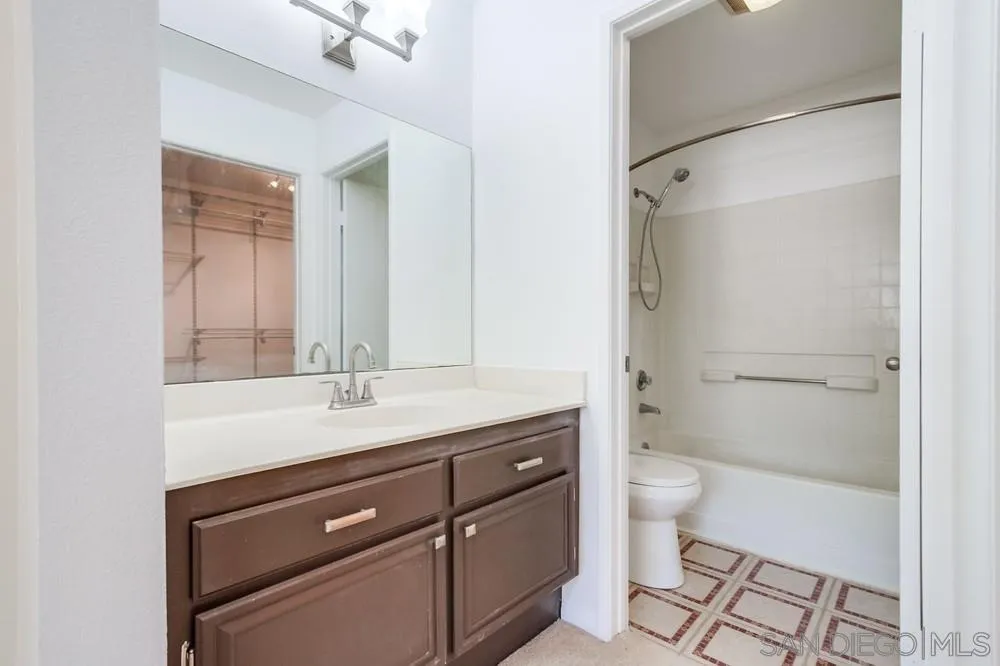 17161 Alva Road, Unit 2323 San Diego, CA 92127 - Photo 17 of 23 a bathroom with a sink a toilet a mirror and shower