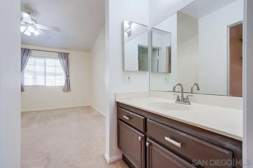 17161 Alva Road, Unit 2323 San Diego, CA 92127 - Photo 19 of 23 a bathroom with a sink and a mirror