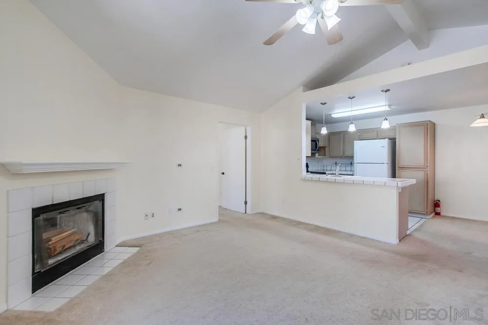 17161 Alva Road, Unit 2323 San Diego, CA 92127 - Photo 6 of 23 an empty room with a fireplace and fan