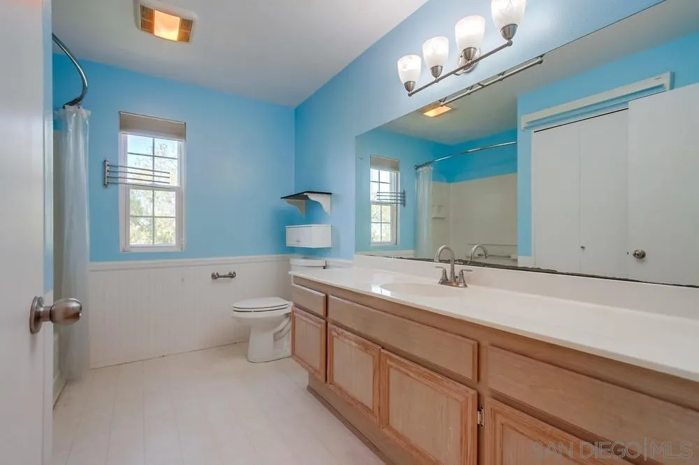 17161 Alva Road, Unit 2323 San Diego, CA 92127 - Photo 9 of 23 a spacious bathroom with a granite countertop sink a toilet and a mirror