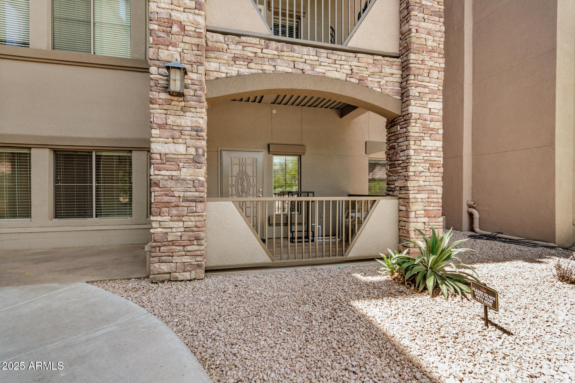 5450 East Deer Valley Drive, Unit 1211 Phoenix, AZ 85054 - Photo 12 of 26 a front view of a house with a garden