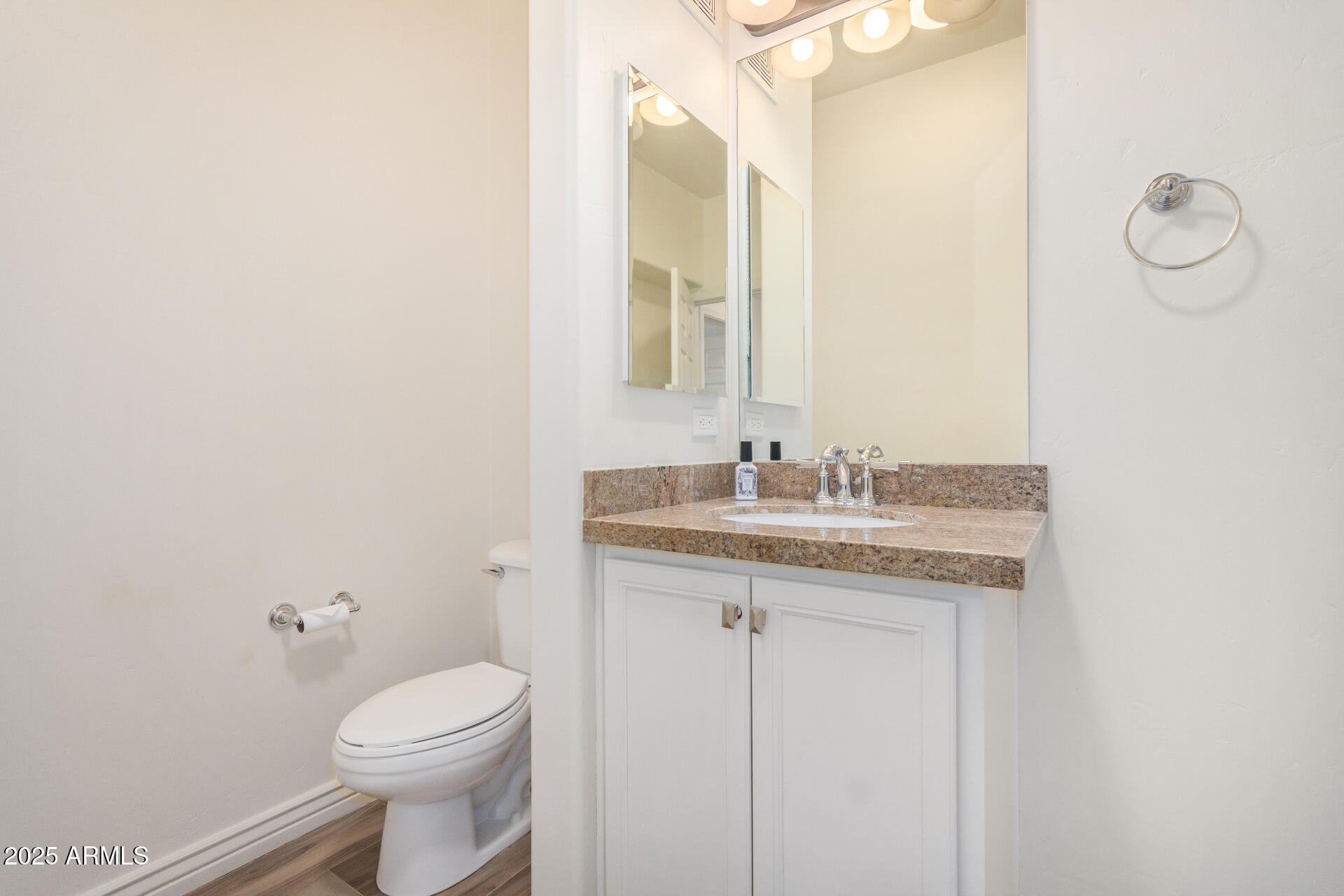 5450 East Deer Valley Drive, Unit 1211 Phoenix, AZ 85054 - Photo 14 of 26 a bathroom with a granite countertop sink a toilet and a mirror
