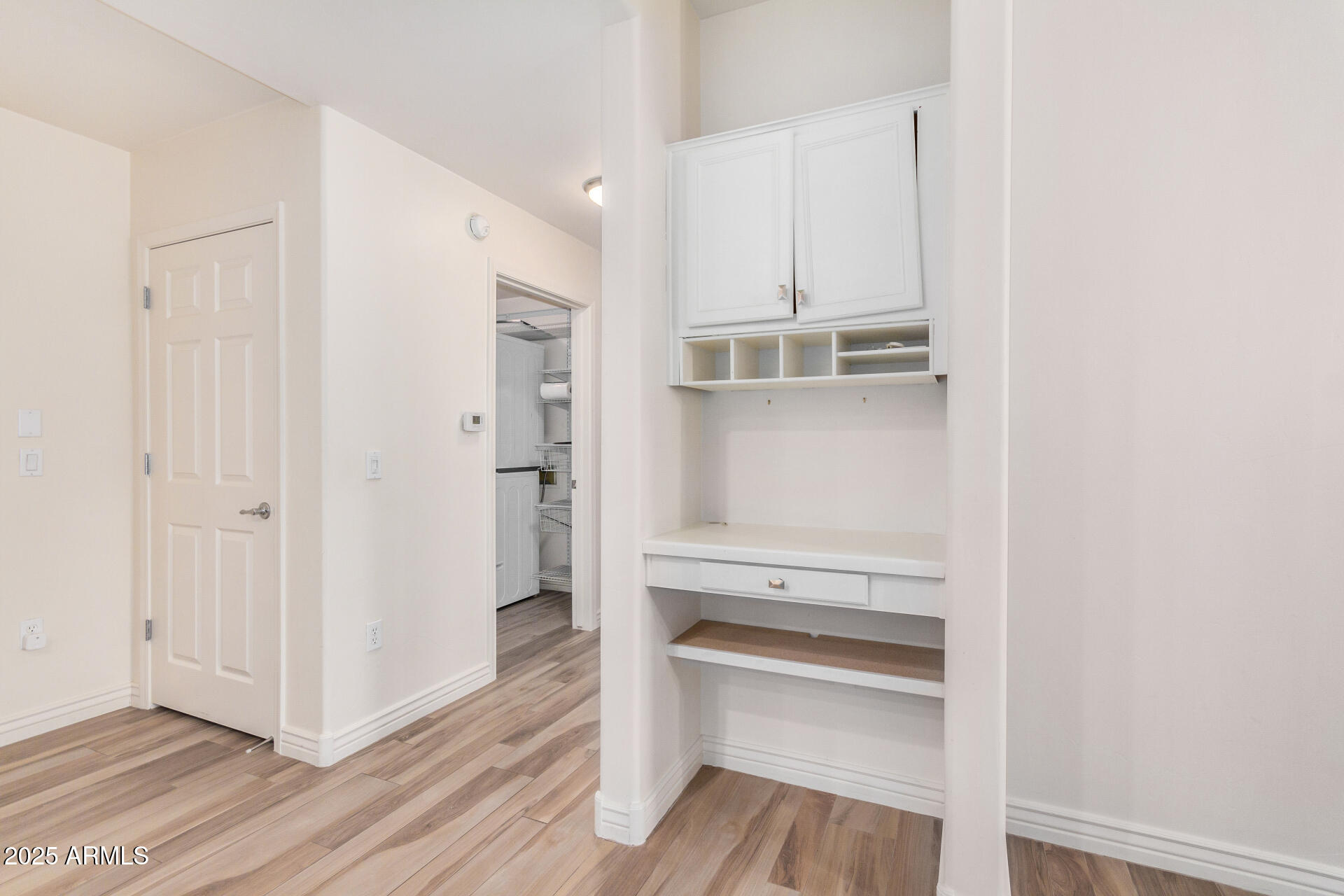 5450 East Deer Valley Drive, Unit 1211 Phoenix, AZ 85054 - Photo 16 of 26 a view of walk in closet with wooden floor
