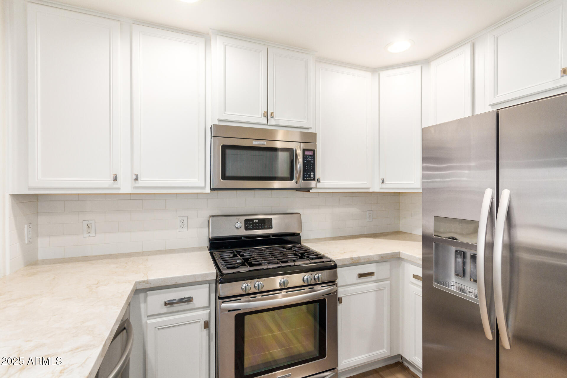 5450 East Deer Valley Drive, Unit 1211 Phoenix, AZ 85054 - Photo 2 of 26 a kitchen with stainless steel appliances granite countertop a stove a microwave and a refrigerator