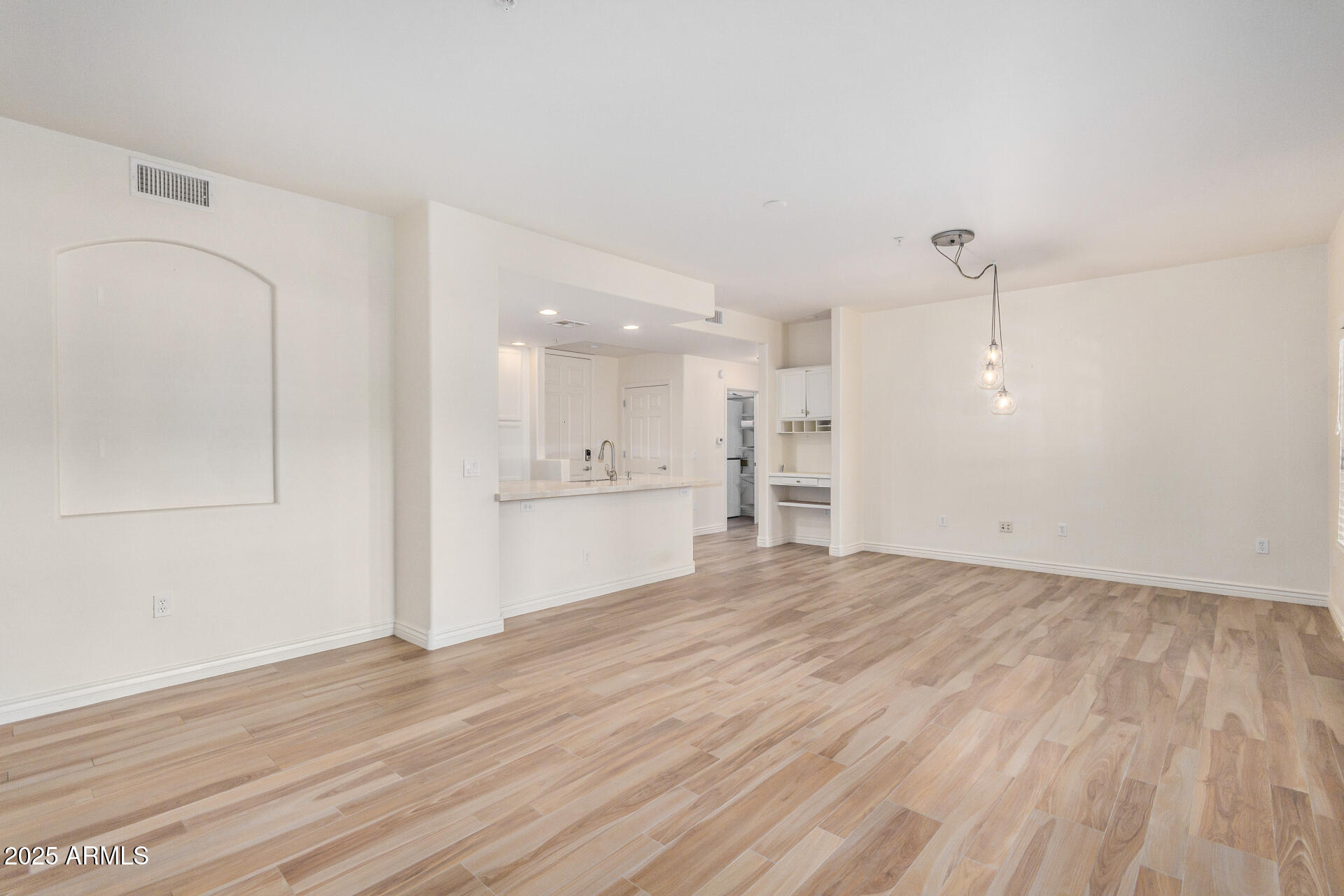 5450 East Deer Valley Drive, Unit 1211 Phoenix, AZ 85054 - Photo 23 of 26 a view of an empty room with a kitchen