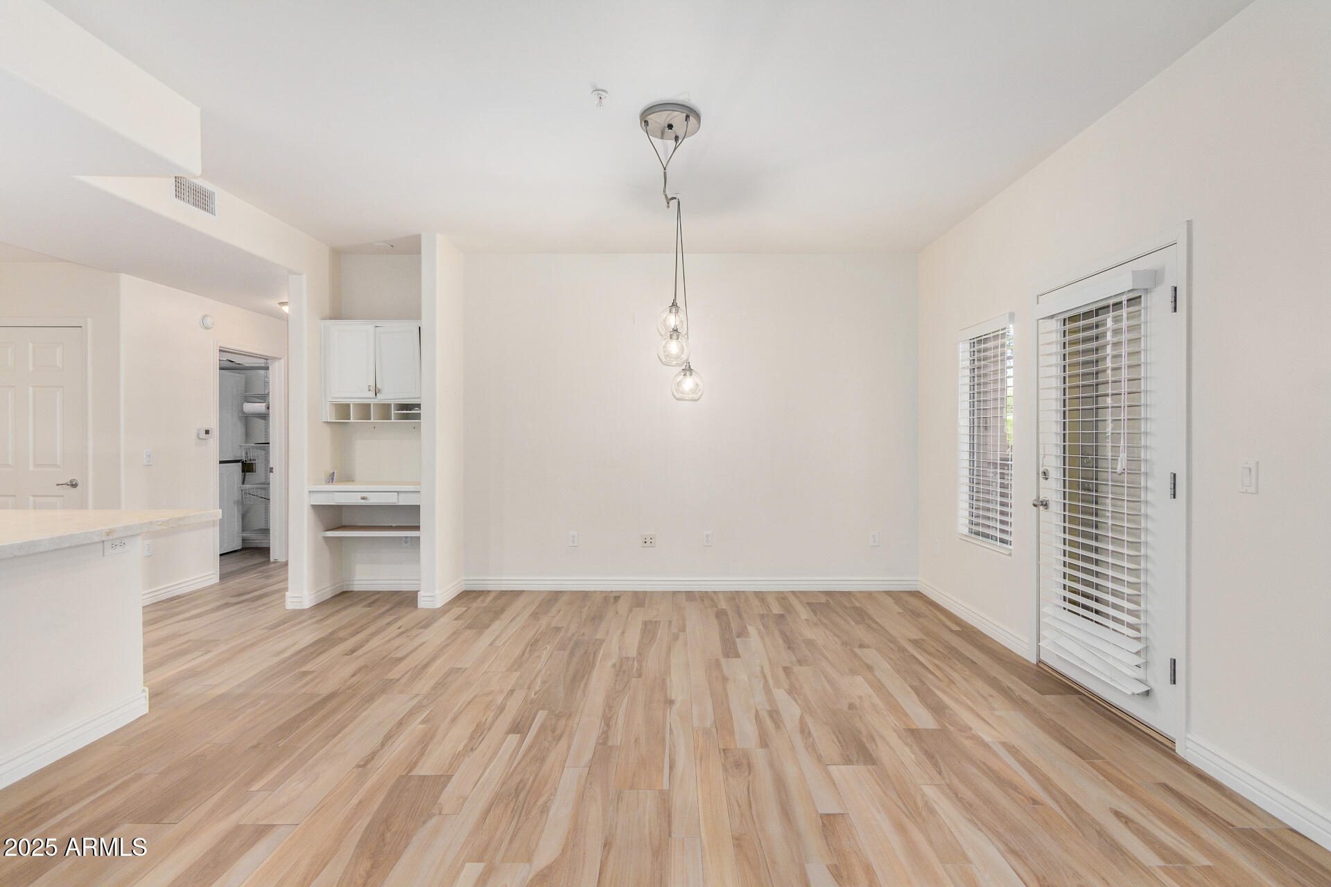 5450 East Deer Valley Drive, Unit 1211 Phoenix, AZ 85054 - Photo 24 of 26 a view of empty room with wooden floor and window